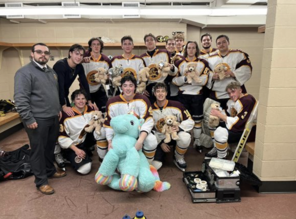 Gannon University’s Hockey Club surrounded by teddy bears after game against Penn State Behrend on December 8th, 2023, for toy drive teddy bear toss.
